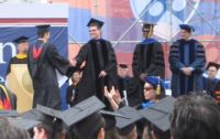 Ryan Goldstein on stage with Eric Schmidt, CEO of Google, at the 2009 Penn Engineering graduation